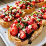 Für die perfekte Erdbeer-Basilikum-Bruschetta brauchen Sie: - 1 französisches Baguette, in 1,25 cm dicke Scheiben geschnitten - 500 g frische Erdbeeren, entkelcht und gewürfelt - 60 ml frische Basilikumblätter, fein gehackt - 45 ml Balsamico-Glasur - 30 ml Olivenöl - 1 Knoblauchzehe, halbiert - Salz und Pfeffer nach Geschmack Diese Zutaten sind einfach zu finden und machen das Gericht frisch und lecker. Um den Geschmack zu verbessern, können Sie folgende Zutaten hinzufügen: - Zerbröckelter Fetakäse - Frische Mozzarella in kleinen Stücken Diese Optionen geben der Bruschetta eine cremige Note und passen gut zu den Erdbeeren. Frische Zutaten sind der Schlüssel zu einem großartigen Gericht. Achten Sie darauf: - Wählen Sie reife Erdbeeren, die süß und saftig sind. - Verwenden Sie frische Basilikumblätter, die einen starken Duft haben. - Das Baguette sollte knusprig und frisch sein. Kaufen Sie die Zutaten am besten am Tag, an dem Sie die Bruschetta zubereiten. So bleibt alles frisch und geschmackvoll. Heize deinen Ofen auf 200°C vor. Das ist wichtig für die perfekte Knusprigkeit. Nimm ein französisches Baguette und schneide es in 1,25 cm dicke Scheiben. Lege die Scheiben in einer einzigen Schicht auf ein Backblech. Bestreiche jede Scheibe leicht mit Olivenöl auf beiden Seiten. So wird das Brot schön goldbraun. Röste die Baguettescheiben im Ofen für etwa 5 bis 7 Minuten. Achte darauf, dass sie knusprig und goldbraun sind. Während das Brot röstet, kannst du die Erdbeermischung machen. Nimm 500 g frische Erdbeeren und entkelche sie. Würfle die Erdbeeren in kleine Stücke. In einer Schüssel vermenge die gewürfelten Erdbeeren mit 60 ml fein gehackten Basilikumblättern. Das bringt einen tollen Geschmack. Jetzt träufle 45 ml Balsamico-Glasur über die Mischung. Rühre alles vorsichtig um, bis die Erdbeeren gut bedeckt sind. Füge Salz und Pfeffer nach Geschmack hinzu. Sobald das Brot fertig ist, nimm das Backblech aus dem Ofen. Reibe die Schnittseite einer halbierten Knoblauchzehe über jede geröstete Scheibe. Das gibt einen tollen Aroma-Kick. Jetzt kommt der beste Teil: Gib auf jede Baguettescheibe einen großzügigen Löffel von der Erdbeer-Basilikum-Mischung. Wenn du magst, streue zerbröckelten Fetakäse oder kleine Stücke frischer Mozzarella darüber. Das macht die Bruschetta noch cremiger. Serviere sie sofort als Vorspeise oder Snack. Garniere sie nach Wunsch mit frischem Basilikum. Um das Brot perfekt zu rösten, heize deinen Ofen auf 200°C vor. Schneide das Baguette in 1,25 cm dicke Scheiben. Lege die Scheiben auf ein Backblech. Bestreiche jede Seite leicht mit Olivenöl. Röste sie für 5-7 Minuten. Achte darauf, dass sie goldbraun und knusprig sind. Das gibt der Bruschetta eine tolle Textur. Wenn du das Brot gleichmäßig röstest, bekommst du die beste Basis für dein Gericht. Die Präsentation macht viel aus. Lege die gerösteten Baguettescheiben auf ein großes Tablett. Fülle jede Scheibe mit der Erdbeer-Basilikum-Mischung. Achte darauf, dass du genug von der Mischung verwendest. Das macht die Bruschetta einladend und schön. Du kannst frische Basilikumblätter als Garnitur verwenden. Das gibt einen frischen Farbklecks und sieht toll aus. Wenn du gerne experimentierst, gibt es viele Anpassungen. Du kannst andere Früchte hinzufügen, wie Pfirsiche oder Tomaten. Diese Früchte passen gut zu Basilikum. Probiere auch verschiedene Käsesorten aus. Feta gibt einen tollen, salzigen Geschmack. Mozzarella sorgt für Cremigkeit. Du kannst auch Nüsse oder Samen für zusätzlichen Crunch hinzufügen. Sei kreativ und finde deinen eigenen Stil! {{image_4}} Erdbeer-Basilikum-Bruschetta ist von Natur aus vegetarisch. Wenn Sie eine vegane Version machen möchten, lassen Sie den Käse einfach weg. Das bringt frischen Geschmack. Sie können auch Avocado hinzufügen. Sie ist cremig und gesund. Die Zutaten können je nach Saison variieren. Im Sommer sind Erdbeeren am besten. Im Herbst können Sie Äpfel oder Birnen nutzen. Diese Früchte passen gut zu Basilikum. Im Winter probieren Sie vielleicht getrocknete Früchte mit einer Prise Zimt. Das gibt einen warmen, süßen Geschmack. Experimentieren Sie mit anderen Früchten. Pfirsiche und Himbeeren sind tolle Optionen. Sie bringen frische Aromen mit. Auch Kräuter können variieren. Minze oder Oregano geben einen neuen Twist. Diese Kombinationen machen das Gericht spannend und lecker. Wenn du Bruschetta übrig hast, lagere sie in einem luftdichten Behälter. Das hilft, die Frische zu bewahren. Lege ein Stück Küchenpapier in den Behälter. Es nimmt die Feuchtigkeit auf und hält das Brot knusprig. Bewahre die Bruschetta im Kühlschrank auf, aber esse sie innerhalb von zwei Tagen. Wenn du noch Erdbeeren oder Basilikum hast, nutze sie für andere Gerichte. Du kannst die Erdbeeren in Joghurt oder Müsli geben. Sie passen auch gut zu Salaten. Basilikum lässt sich gut in Pesto oder als Gewürz für Pasta verwenden. Diese Ideen helfen, Lebensmittel zu retten und Abfall zu vermeiden. Die Haltbarkeit der Bruschetta hängt von den Zutaten ab. Das Brot bleibt bis zu zwei Tage frisch im Kühlschrank. Die Erdbeermischung sollte innerhalb von drei Tagen gegessen werden. Achte darauf, die Mischung immer gut zu verschließen. Wenn du einen seltsamen Geruch oder eine Veränderung der Farbe bemerkst, wirf sie weg. Sicherheit ist wichtig, auch bei köstlichen Speisen! Ja, du kannst andere Brotsorten verwenden. Baguette ist knusprig und lecker. Aber auch Ciabatta oder Vollkornbrot funktionieren gut. Der Geschmack kann sich leicht ändern, aber das ist okay. Probiere verschiedene Brote aus und finde deinen Favoriten! Du kannst die Erdbeermischung bis zu zwei Stunden im Voraus zubereiten. Lagere sie im Kühlschrank, damit sie frisch bleibt. Das Balsamico hilft, die Aromen gut zu verbinden. Rühre kurz vor dem Servieren um, um alles gut zu vermischen. Zu Erdbeer-Basilikum-Bruschetta passen leichte Getränke gut. Ein trockener Weißwein, wie Sauvignon Blanc, harmoniert klasse. Auch Prosecco oder ein frischer Spritz passt gut dazu. Für eine alkoholfreie Option kannst du Mineralwasser mit Zitrone wählen. Diese Getränke heben die Aromen der Bruschetta hervor. Diese Anleitung zeigt, wie Sie leckere Erdbeer-Basilikum-Bruschetta zubereiten. Sie lernten die besten Zutaten kennen und wie Sie sie frisch halten. Ich gab Tipps zur perfekten Röstung und kreativen Varianten. Denken Sie daran, dass Reste gut gelagert werden können. Variieren Sie die Rezepte nach Ihrem Geschmack. Lassen Sie Ihrer Kreativität freien Lauf, um neue Kombinationen zu entdecken. Genießen Sie Ihre Bruschetta mit Freunden oder Familie. Es wird sicher ein Hit!