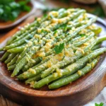 - 450 g frische grüne Bohnen - 2 Esslöffel Olivenöl - 3 Zehen Knoblauch, fein gehackt - 1 Teelöffel Knoblauchpulver - 1 Teelöffel Zwiebelpulver - ½ Tasse geriebener Parmesan-Käse - ½ Teelöffel zerstoßene rote Pfefferflocken - Salz und Pfeffer nach Geschmack - Frische Petersilie zur Garnitur Die Zutaten für die Air Fryer Garlic Parmesan Green Bean Fries sind einfach und frisch. Die grünen Bohnen sind das Herzstück. Wenn Sie diese Bohnen putzen, achten Sie auf die Qualität. Nehmen Sie die besten Bohnen, die Sie finden können. Olivenöl bringt einen feinen Geschmack und hilft den Bohnen, schön knusprig zu werden. Der Knoblauch gibt den Bohnen eine tolle Würze. Ich verwende frischen Knoblauch, denn er hat einen intensiveren Geschmack als Pulver. Die Gewürze sind wichtig. Das Knoblauchpulver und das Zwiebelpulver verstärken die Aromen. Parmesan-Käse macht die Bohnen cremig und lecker. Wenn Sie es schärfer mögen, fügen Sie die zerstoßenen roten Pfefferflocken hinzu. Vergessen Sie nicht, Salz und Pfeffer hinzuzufügen. Diese Grundgewürze bringen die Aromen zur Geltung. Für eine frische Note können Sie die Bohnen mit Petersilie garnieren. Diese Zutaten sorgen für einen vollen, reichen Geschmack. Heize deinen Air Fryer auf 200 °C vor. Das dauert etwa fünf Minuten. Währenddessen kannst du die grünen Bohnen putzen. Entferne die Enden und wasche sie gründlich. So sind sie bereit für die Marinade. Gib die frisch geputzten Bohnen in eine große Schüssel. Füge zwei Esslöffel Olivenöl hinzu. Dann kommt der fein gehackte Knoblauch, das Knoblauchpulver, das Zwiebelpulver und die zerstoßenen roten Pfefferflocken. Mische alles gut, bis die Bohnen gleichmäßig bedeckt sind. Jetzt streue den Parmesan über die Bohnen und vermenge ihn vorsichtig. So haben alle Bohnen etwas Käse. Lege die Bohnen in den Korb des Air Fryers. Achte darauf, dass sie in einer einzigen Schicht liegen. So werden sie gleichmäßiger knusprig. Frittiere die Bohnen für acht bis zehn Minuten. Schüttle den Korb nach der Hälfte der Zeit. So garen sie von allen Seiten. Nach dem Frittieren kannst du die Bohnen auf eine Servierplatte geben. Garniere sie nach Belieben mit mehr Parmesan und frischer Petersilie. Um die perfekten grünen Bohnen zu bekommen, musst du die Garzeit anpassen. Frittiere die Bohnen für 8 bis 10 Minuten. Schüttle den Korb nach fünf Minuten. So werden sie gleichmäßig knusprig. Wenn du sie länger frittierst, können sie weich werden. Achte darauf, dass die Bohnen in einer einzigen Schicht liegen. Überfüllung kann zu ungleichmäßiger Garung führen. Frische Bohnen haben den besten Geschmack und die beste Textur. Sie sind knackiger und behalten ihre Farbe. Wenn du gefrorene Bohnen verwenden möchtest, tau sie zuerst auf. Tupfe sie trocken, bevor du sie mit Öl und Gewürzen vermengst. So wird das Frittieren erfolgreicher. Gefrorene Bohnen brauchen oft etwas länger. Prüfe sie regelmäßig. Du kannst verschiedene Käsesorten ausprobieren. Cheddar oder Gouda geben den Bohnen einen neuen Geschmack. Wenn du vegan kochen möchtest, gibt es viele gute Käsealternativen. Für die Gewürze kannst du experimentieren. Versuche italienische Kräuter wie Oregano oder Thymian. Diese passen gut zu Bohnen und Parmesan. Zitrusaromen bringen Frische in die Mischung. {{image_4}} Du kannst verschiedene Käsesorten verwenden. Cheddar gibt einen kräftigen Geschmack. Gouda fügt eine milde, cremige Note hinzu. Diese Käsevariationen machen dein Gericht spannend. Wenn du vegane Optionen magst, probiere vegane Käsealternativen. Diese sind oft aus Nüssen oder Soja. Sie schmelzen gut und geben einen tollen Geschmack. Du kannst auch mit Gewürzen spielen. Asiatische Gewürze bringen ein neues Aroma. Denk an Ingwer oder Sojasauce. Italienische Gewürze wie Oregano oder Basilikum passen ebenfalls gut. Experimentiere auch mit Zitrusaromen. Zitrone oder Limette geben Frische. Diese Gewürzvariationen bringen Abwechslung in dein Gericht. Es gibt viele Möglichkeiten, zusätzliche Zutaten hinzuzufügen. Geröstetes Gemüse wie Paprika oder Zucchini passt gut. Sie verleihen deinem Gericht mehr Geschmack und Farbe. Du kannst auch andere Gemüsesorten kombinieren. Karotten oder Süßkartoffeln sind lecker und machen das Gericht vielfältig. Diese zusätzlichen Zutaten machen deine Bohnen noch besser. - Kühlschranklagerung: Lagern Sie die Bohnen in einem luftdichten Behälter. So bleiben sie frisch. - Gefrieroptionen: Sie können die gekochten Bohnen auch einfrieren. Legen Sie sie in einen Gefrierbeutel. - Maximaler Zeitraum im Kühlschrank: Im Kühlschrank halten die Bohnen bis zu drei Tage. - Tipps zum Wiederaufwärmen: Nutzen Sie den Air Fryer oder eine Pfanne. So bleiben sie knusprig. - Ideen für schnelle Gerichte: Fügen Sie die Bohnen zu Rühreiern oder Pasta hinzu. - Verwendung in Salaten oder als Snack: Mischen Sie sie mit frischem Gemüse. Sie sind auch ein toller Snack für zwischendurch. Die optimale Garzeit für grüne Bohnen im Air Fryer beträgt 8-10 Minuten bei 200 °C. Ich empfehle, die Bohnen nach der Hälfte der Zeit zu schütteln. So werden sie gleichmäßig gar und knusprig. Die Bohnen sollten goldbraun sein, wenn sie fertig sind. Achte darauf, die Bohnen in einer einzigen Schicht zu frittieren, um die beste Textur zu erreichen. Ja, gefrorene Bohnen können auch verwendet werden. Wenn du gefrorene Bohnen nimmst, lasse sie etwas antauen. Das hilft, die Garzeit zu reduzieren. Du solltest sie auch gut abtropfen lassen. So vermeidest du, dass sie beim Frittieren zu viel Feuchtigkeit abgeben. Es kann sein, dass du die Garzeit leicht anpassen musst. Achte darauf, sie regelmäßig zu prüfen. Um die Bohnen noch knuspriger zu machen, gibt es einige Tipps. Verwende mehr Parmesan-Käse, um die knusprige Schicht zu erhöhen. Du kannst auch weniger Öl verwenden. Dadurch wird der Frittierprozess trockener. Eine weitere Idee ist, die Bohnen vor dem Frittieren leicht mit Maisstärke zu bestäuben. Das hilft, die Knusprigkeit zu verbessern. Achte darauf, dass die Bohnen nicht übereinander liegen. In diesem Blogpost haben wir die Hauptzutaten für unsere köstlichen Air Fryer Bohnen besprochen. Ich habe erklärt, wie man sie vorbereitet, marinieren und frittieren kann. Wir haben auch hilfreiche Tipps zur Konsistenz und zur Nutzung frischer oder gefrorener Bohnen gegeben. Zum Schluss: Sei kreativ mit Gewürzen und Käse. Experimentiere mit neuen Zutaten und Variationen. So wird dein Gericht noch besser. Genieß deine knusprigen Bohnen!